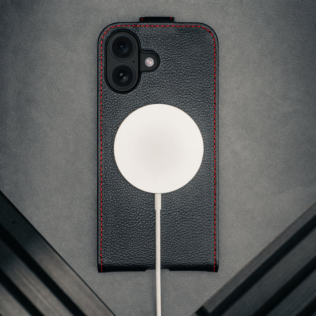 MagSafe charger attached to the Black with Red Stitching Leather Flip Case for iPhone 17