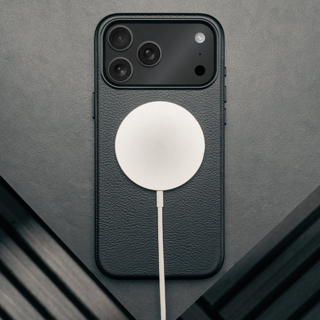 MagSafe charger attached to the Slimline Black Leather Bumper Case for iPhone 17 Pro