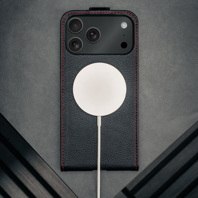 MagSafe charger attached to the Black with Red Stitching Leather Flip Case for iPhone 17 Pro Max