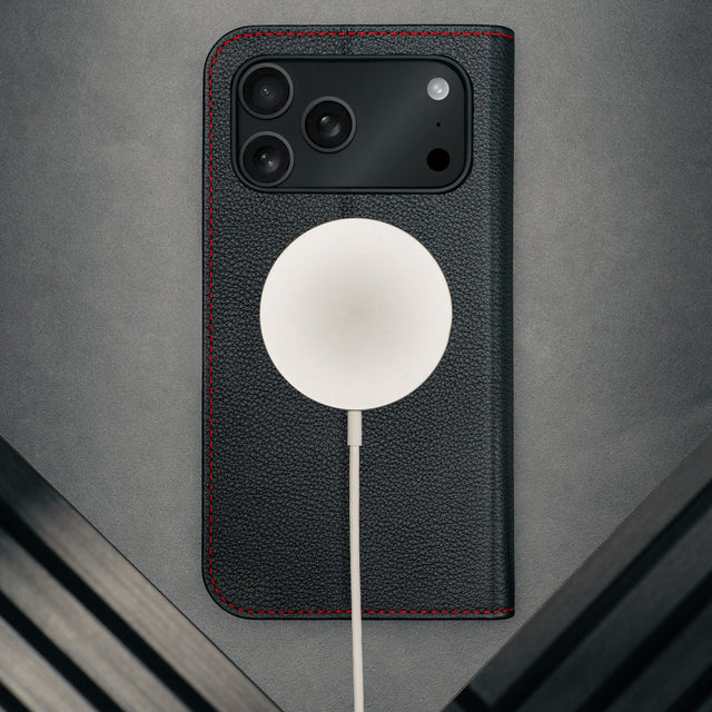 MagSafe charger attached to the Black Leather Case (with Red Stitching) for iPhone 17 Pro