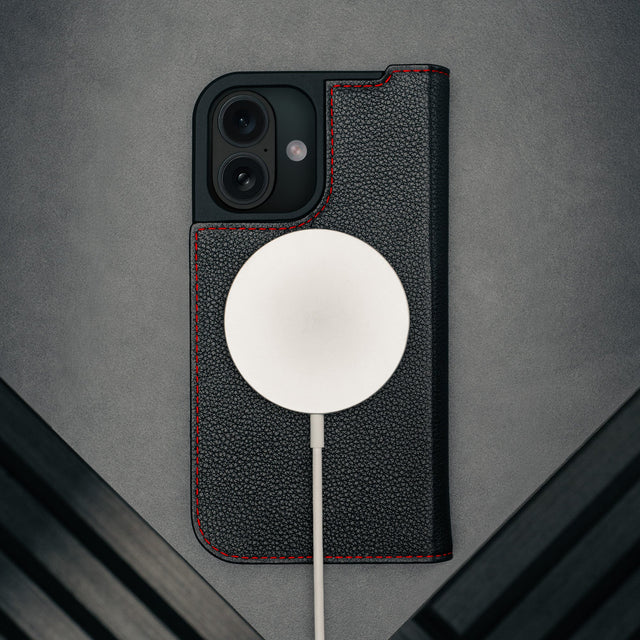 MagSafe charger attached to the Black (with Red Detail) Leather Case for iPhone 17