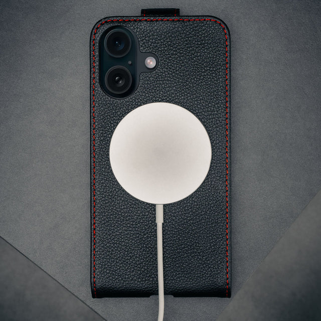 MagSafe charger attached to the Black with Red Stitching Leather Flip Case for iPhone 16