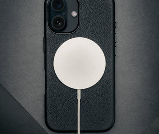 MagSafe charger connected to the Black Leather Slimline Bumper Case for iPhone 16