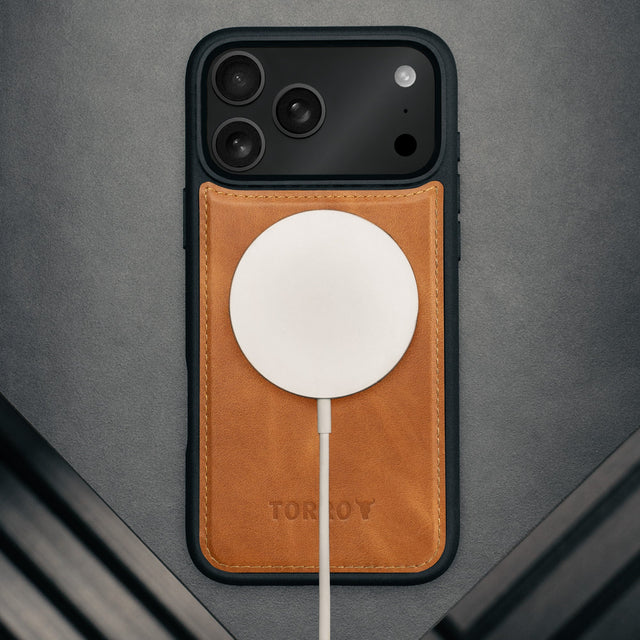 MagSafe charger attached to the Dark Brown Leather Detachable Case for iPhone 17 Pro