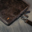 Dark Brown Leather Messenger Bag on a wooden table