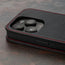 Camera cutout on the Black with Red Detail Leather Flip Case for iPhone 15 Pro Max
