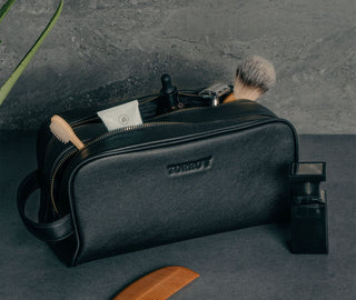 Toiletry items inside the Black Leather Wash Bag